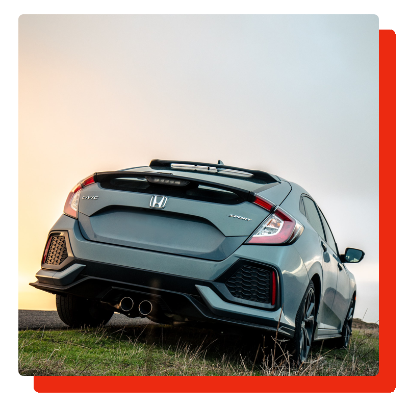 rear view of honda civic sport parked in the road