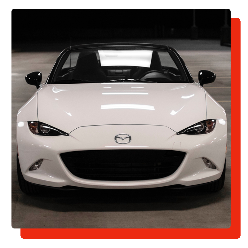white Mazda parked in the parking area white Mazda parked in the parking area